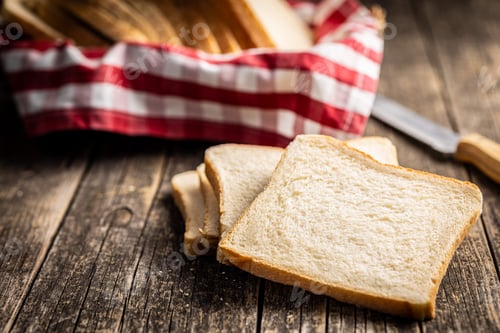 Preview: White sliced toast bread on wooden table.