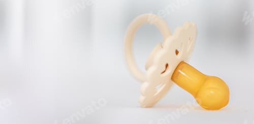 Preview: Baby's pacifier on a blurred white background.