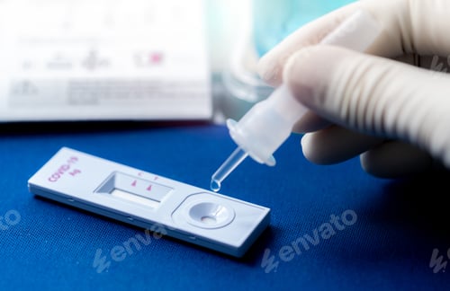 Preview: Hand holding sample tube and drops in the test device of covid 19 antigen self test. Antigen test