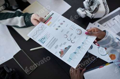 Preview: Colleagues examining document with graphs