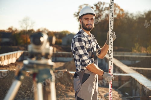 Preview: In white hardhat. Worker is on the construction site at daytime