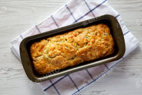 Preview: Homemade Cheesy Bread Loaf on a white wooden background, top view. Flat lay, overhead, from above.