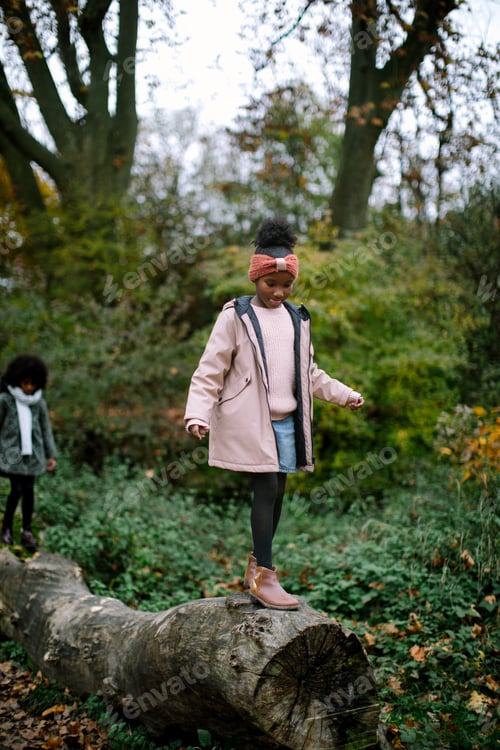 Preview: Twin sisters in the woods jumping off of a tree log