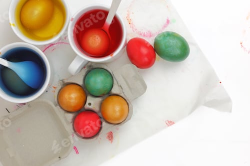 Preview: Colored Easter eggs and liquid color dyes on white background