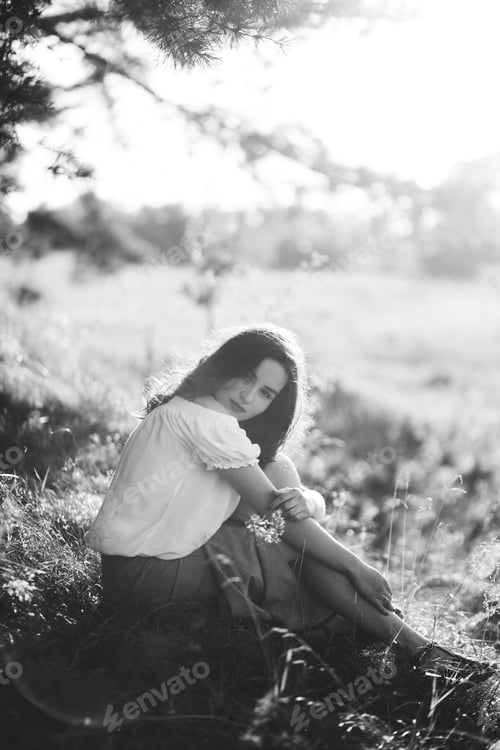 Preview: Young woman walking in forest