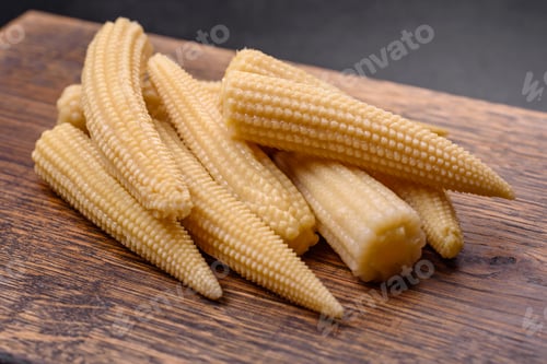 Preview: A bunch of small white canned corn on a dark concrete background