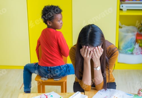 Preview: Teacher get headache with two naughty kids in classroom at kindergarten