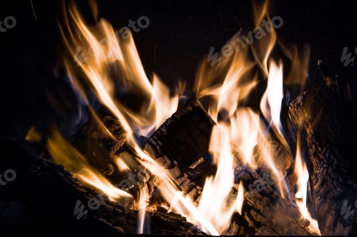 Preview: Fire orange tongues on black background in a brick fireplace