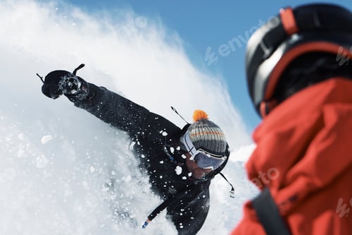 Preview: Male snowboarder speeding down mountainside, over shoulder view, Alpe-d'Huez, Rhone-Alpes, France