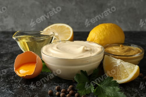 Preview: Bowl with mayonnaise and ingredients for cooking on black smokey background
