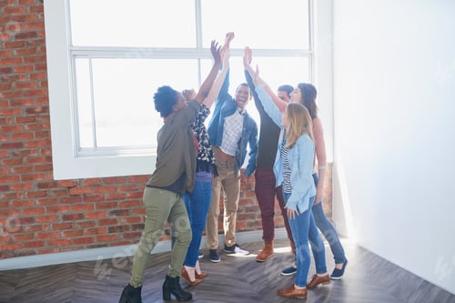 Preview: Shot of a group of university students high fiving one another during class