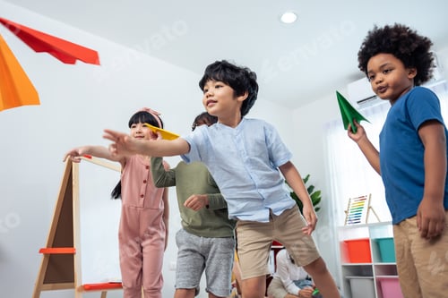 Preview: Children Launching Colorful Paper Airplanes Indoors