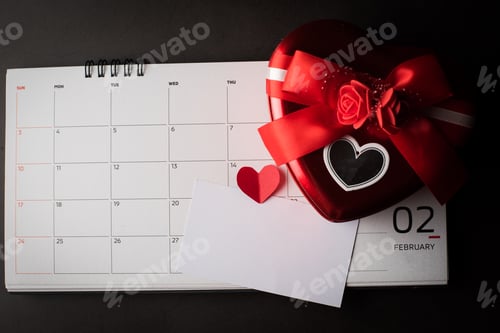 Preview: February 14 on the calendar with Heart shaped gift box and blank note card, Valentine's day concept