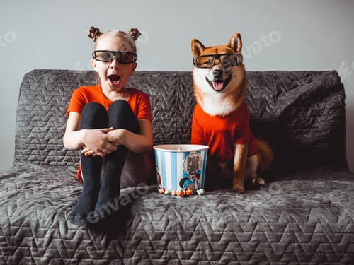 Preview: A little girl and her funny dog watch a movie in 3D glasses.Emotions of surprise and shock