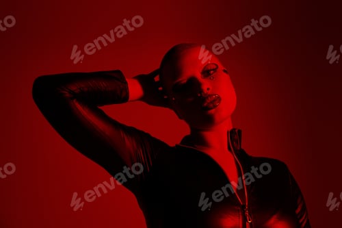 Preview: Young woman with pink hair and bold style posing dramatically in a vibrant studio setting