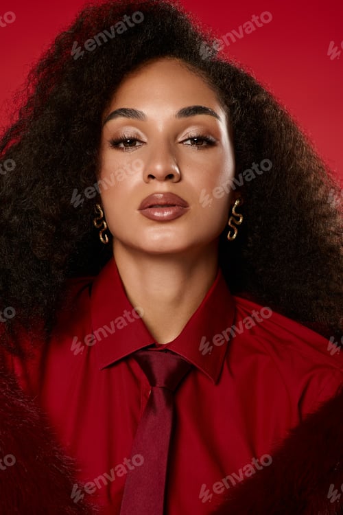 Preview: Trendy autumn fashion showcased by a confident African American woman in studio setting