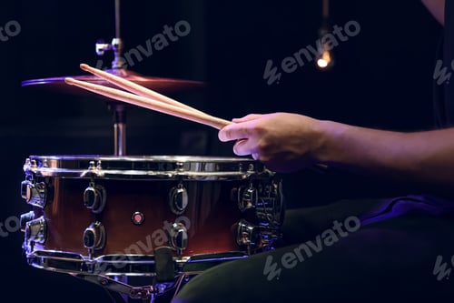 Preview: Drummer playing snare drum with sticks close up.