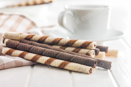 Preview: Assorted Chocolate and Vanilla Cream Filled Wafer rolls on white table.
