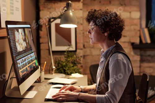 Preview: Professional colorist editing photos on computer