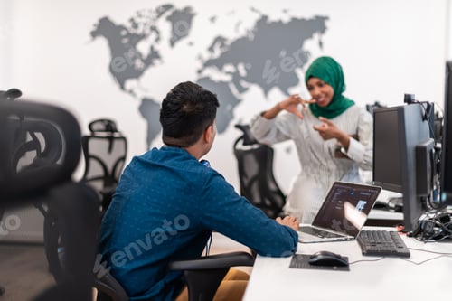 Preview: Multiethnic startup business team woman wearing a hijab on meeting in modern open plan office