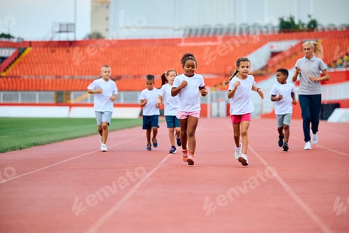 Preview: Group of children running during sport training at the stadium.