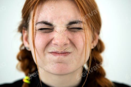 Preview: Close up portrait of angry redhead teenage girl.