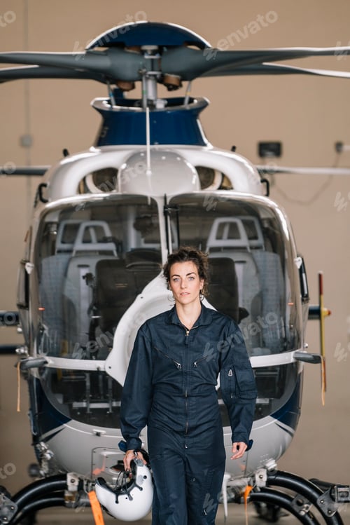 Preview: Pilot girl poses with her helicopter.