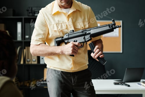 Preview: Cropped shot of mature male coach of military training with carbine