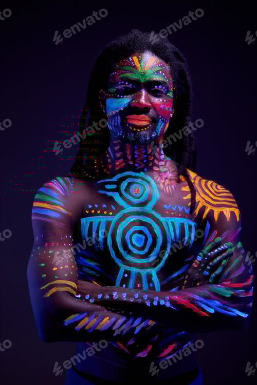 Preview: african man painted in fluorescent paint on face and muscular shirtless torso