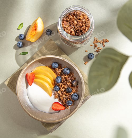 Preview: Natural diet yogurt with homemade granola; peach, strawberry and blueberry in a bowl and jar