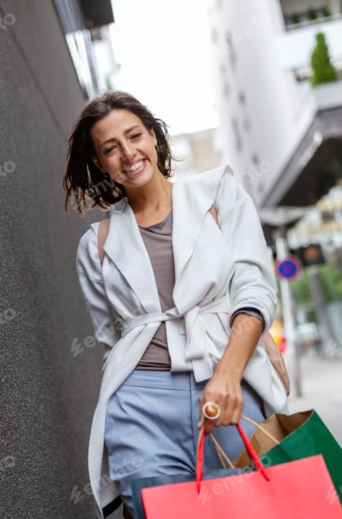 Preview: Happy woman with shopping bags enjoying in shopping. Consumerism, shopping, lifestyle concept
