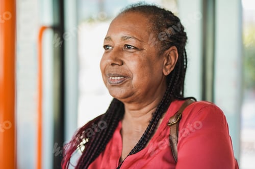 Preview: African senior woman inside tram transportation - Elderly person traveling