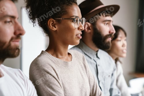 Preview: Image of multiethnic young business workers standing together at office