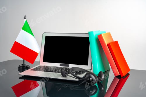 Preview: Laptop with Italy flag on working table, educational concept