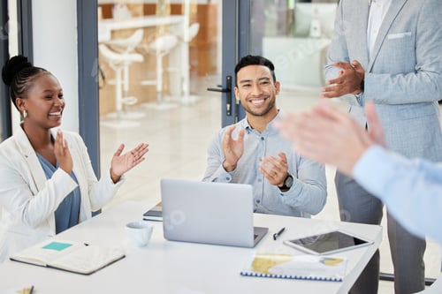 Preview: Shot of businesspeople clapping hands in a boardroom at work