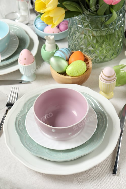 Preview: Easter celebration. Festive table setting with painted eggs.