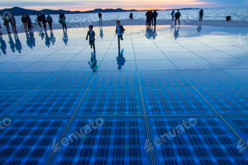 Preview: People reflected in the Greetings of the sun at the sunset in Zadar, Croatia