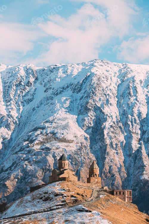 Preview: Stepantsminda, Georgia. Popular Gergeti Trinity Tsminda Sameba Church In Early Winter Landscape