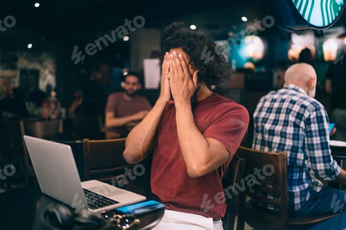 Preview: skilled millennial blogger shy during netbook network browsing in cafe interior