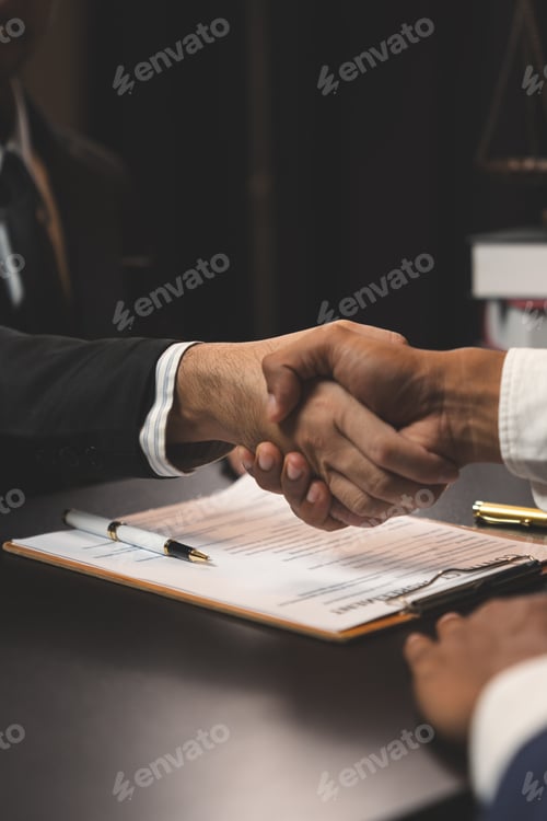 Preview: A professional lawyer shakes hands to congratulate a businessman after discussing a business contrac