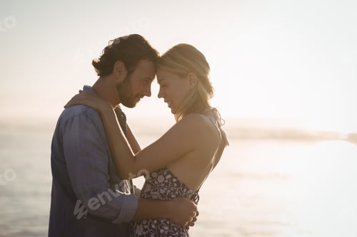 Preview: Young couple embracing at beach