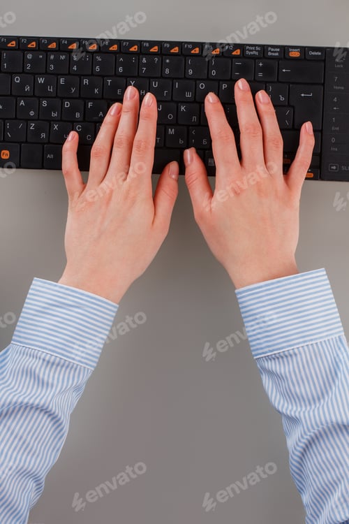 Preview: Top view female hands working on computer keyboard.