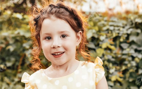 Preview: Happy little girl in garden