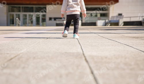 Preview: Little girl with sneakers and leggins training outdoors