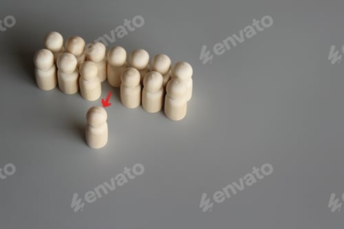 Preview: Selective focus image of one wooden doll leave the group.