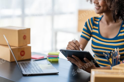 Preview: Pretty young african american woman start up freelance business people is working at warehouse