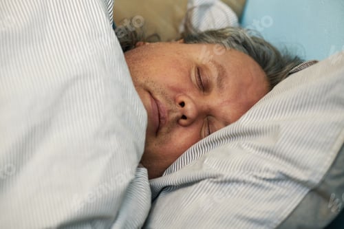 Preview: Sleeping Man Resting On Striped Pillow In Close-Up Frame