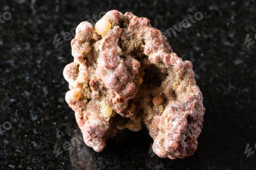 Preview: sample of raw chalcedony rock on black granite