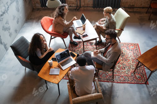 Preview: Several intercultural business people interacting by tables