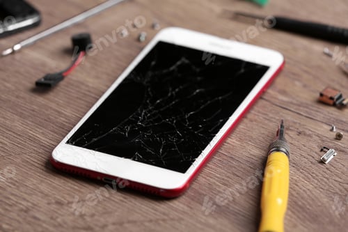 Preview: Modern phone with broken display and repair tools on table
